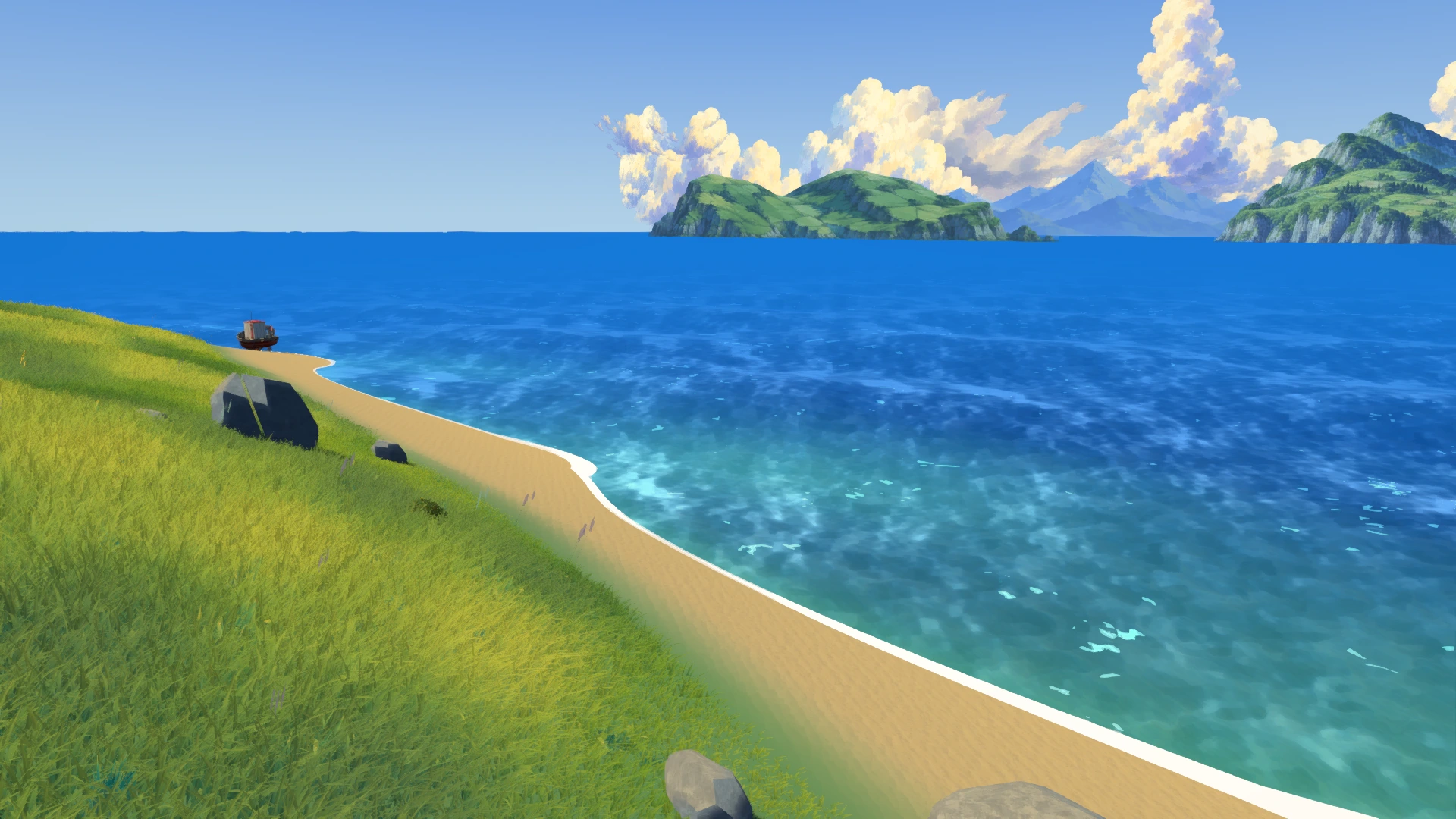 A grassy shoreline beside a sandy beach and blue sea, with islands beyond.